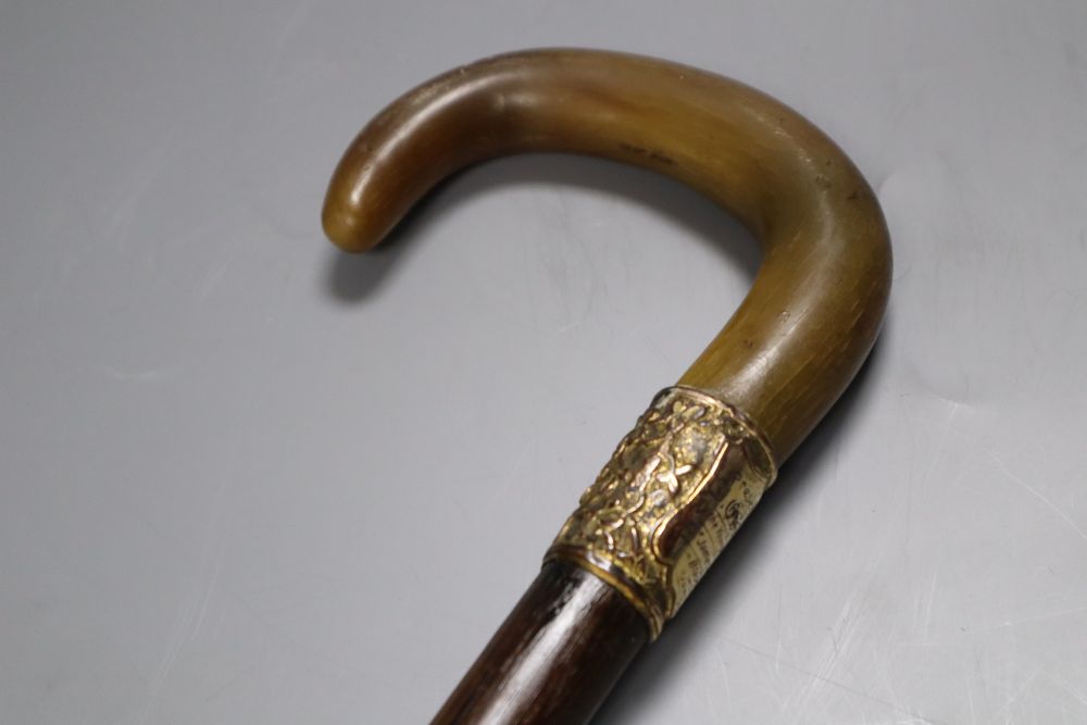 An Edwardian rhinoceros horn handled walking stick, presented 1906, length 88cm